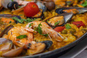 Spanish seafood Paella de Marisco, Paella Marinera with scampi's,  olive tomato