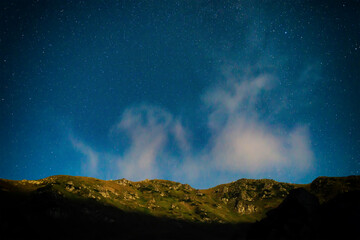 Mountain landscape at night with many stars