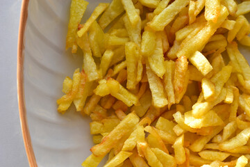 Ruddy delicious crispy French fries just fried close up