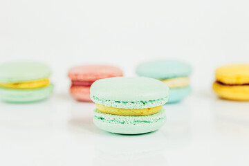 Sweet almond colorful pastel pink blue yellow green macaron or macaroon dessert cake isolated on white background. French sweet cookie. Minimal food bakery concept Copy space