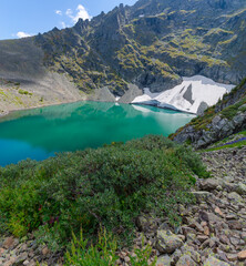 Panorama of a high-altitude lake with a glacier on the shore
