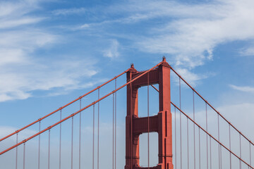 The Golden Gate Bridge, blue skies and white clouds. The Golden Gate Bridge is an iconic suspension bridge located in downtown San Francisco California.