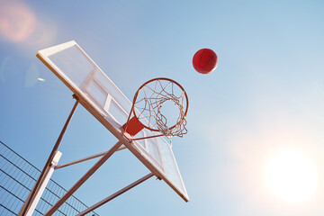 Basketball being thrown into the hoop on sports court