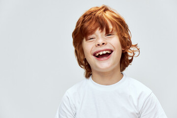 Redhead boy smiles broadly close-up cropped view 