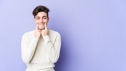 Young caucasian man isolated on purple background doubting between two options.