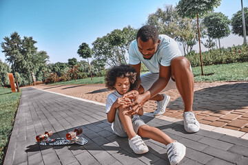 Little scateboarding incident of cute curly child
