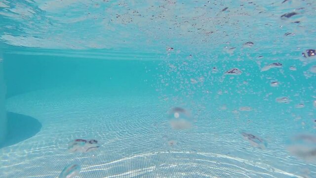 Underwater slow motion video of turquoise exotic empty pool