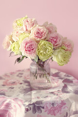 Still life with a fresh roses in a vase.  Pastel tonality. Soft focus.
