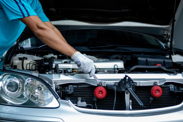 Auto mechanic working in garage. Repair service.