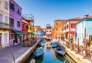 Fototapeta na wymiar Street and colorful facades on a canal on the island of Burano in Venice in Veneto, Italy