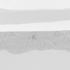 Obraz premium White torn paper collage close-up. Texture made from various paper and cardboard parts. Damaged old paper background. Vintage blank wallpaper. Material design backdrop.