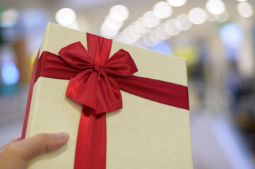 Close up of gift box in shopping mall background, thanksgiving and Christmas concept.