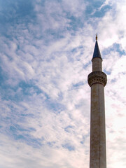 Selimiye Mosque is an Ottoman imperial mosque, the most famous historical monument of Edirne, located in the European part of Turkey. Dramatic minaret silhouette with blue sky and white clouds.
