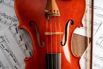 Fototapeta premium Violin body and archer with an undefined musical score