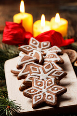 Obraz na płótnie Canvas Christmas gingerbread cookies in star shape on rustic wooden table. Xmas cozy mood