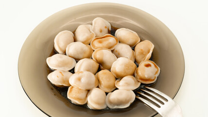 Isolated traditional russian pelmeni, ravioli, dumplings with meat and soy sauce on white background. Design and food styling idea for sale. Home food restaurant, menu or cook book concept