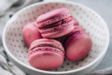 Several small macaroon cakes in a plate close-up