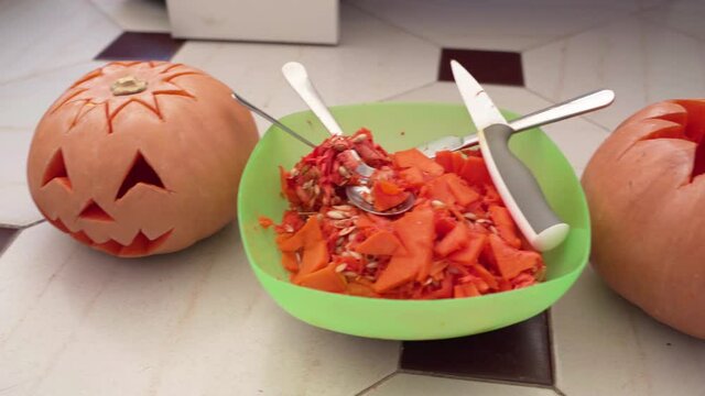 Carving fresh pumpkin heads -perfect Halloween decor -close up pan left