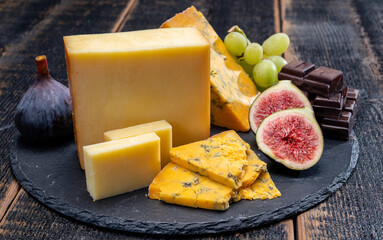 British matured yellow cheese blue shropshire, smoked cheddar and fresh figs close up