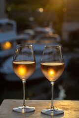 Tasting of local rose wine in summer with sail boats haven of Port Grimaud on background, Provence, France