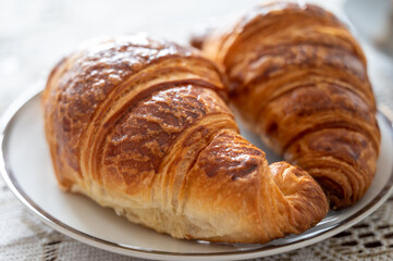 Two fresh baked puff croissants, traditional French breakfast