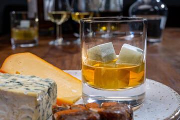Tasting and pairing of different cheeses with strong alcoholic drinks, whisky, cognac or calvados