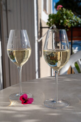 Tasting of local white wine on sunny summer balcony Provence, France