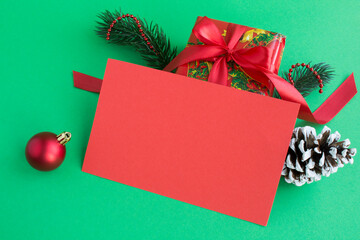 Closeup on blank red paper for Christmas greetings and gift  on the green background