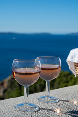 Picnic with of local rose wine and blue Mediterranean sea on background, near Saint-Tropez, Var, Provence, France
