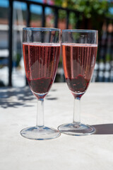 Summer party with sparkling rose champagne wine and sail boats haven of Port Grimaud on background, Provence, France