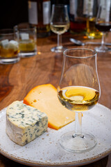 Tasting and pairing of different cheeses with strong alcoholic drinks, whisky, cognac or calvados