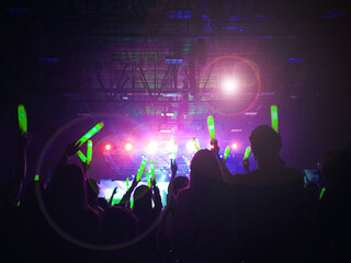 Crowd at concert : Silhouette people crowd happy and cheering with led foam stick light in front of...