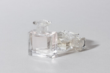 Glass perfume bottles in bright sunlight with harsh shadows.