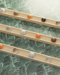 different marbles in a wooden track