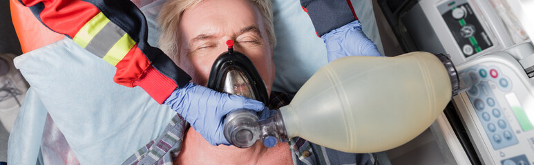 Website header of paramedic doing cardiopulmonary resuscitation to sick patient in ambulance car © LIGHTFIELD STUDIOS