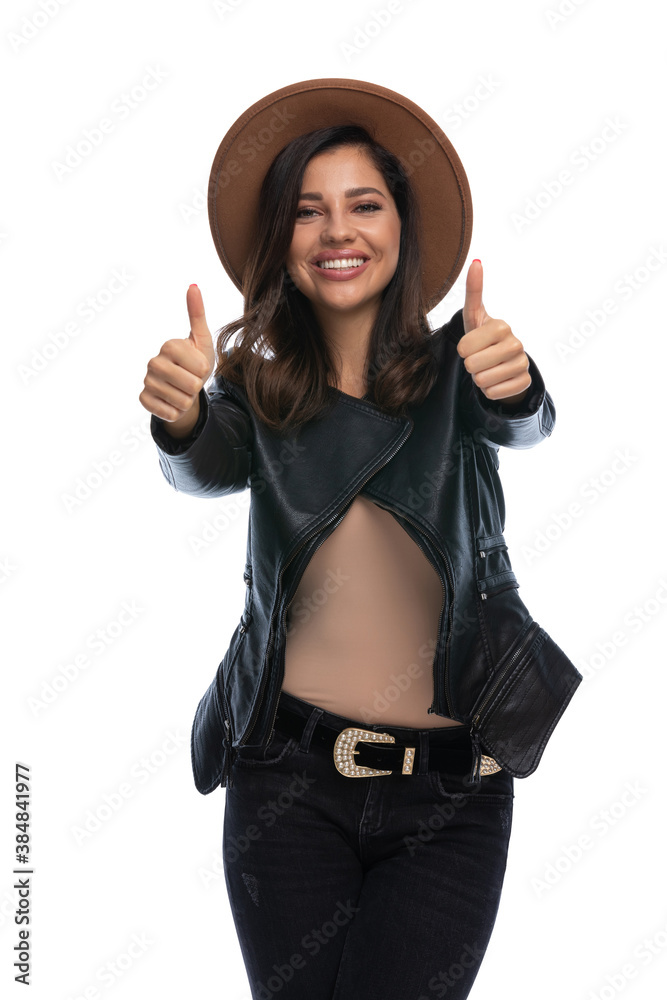 Wall mural Smiling casual woman gesturing ok with both hands, wearing hat