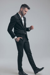 Wondering elegant man holding hand in pocket and walking