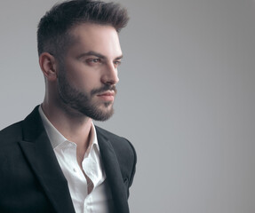 Closeup of confident elegant man looking away, wearing suit