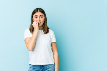 Young caucasian woman biting fingernails, nervous and very anxious.