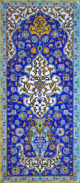 Old, traditional ceramic tiles, pattern of flowers and ornaments, vaulting on the wall in the Golestan Palace complex in Tehran, Iran