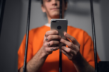 The criminal in the prison cell received a smartphone to communicate with relatives