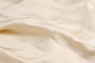 Soft smooth beige silk fabric background. Fabric texture.