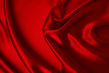 Red silk or satin luxury fabric texture can use as abstract background. Top view.