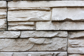 Stone surface gray colored with mottled texture. Rocky wall texture background. Clay sandstone bricks