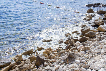 Sea. Coast. Rocky shore. The chair stands on stones by the sea