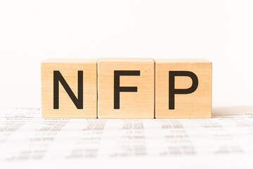 Word nfp. Wooden small cubes with letters isolated on white background with copy space available.Business Concept image.