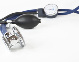 Components of a stethoscope. The acoustic head is in the foreground, the blower and pressure gauge...