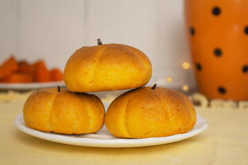 pumpkin shaped cookies on a plate on the table