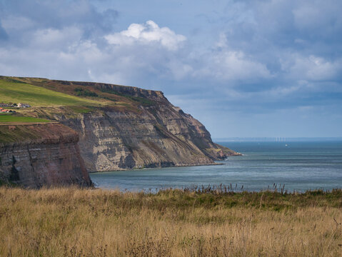 The North Yorkshire coast from the Cleveland Way near Cowbar, Staithes - the strata of the  cliffs are shown, which are part of the Redcar Mudstone Formation - Jurassic sedimentary bedrock