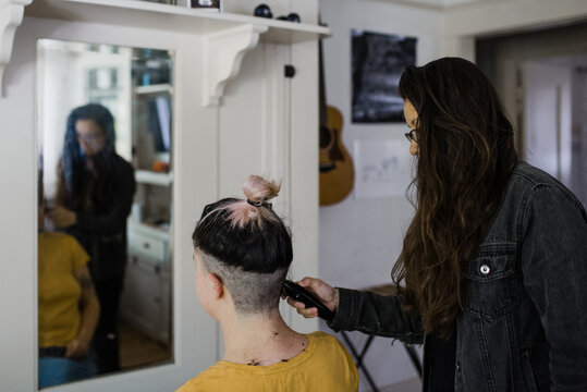 Woman getting hair buzzed off